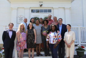 Group of people smiling in front of Long Ridge United Methodist Church, sunny day, diverse ages and attires.