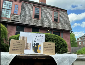 Historic house with signs honoring enslaved individuals Kate and Mina, highlighting their stories and emancipation.