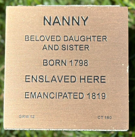 Commemorative plaque for Nanny, born 1798, enslaved and emancipated in 1819, honoring her legacy as a daughter and sister.
