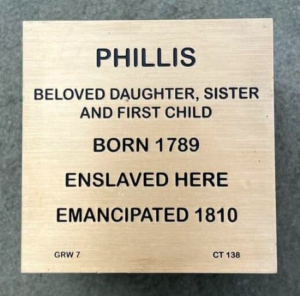 Memorial plaque for Phillis, detailing her life: born 1789, enslaved, emancipated 1810; beloved daughter and sister.