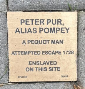 Historic plaque honoring Peter Pur, a Pequot man, enslaved in 1728.