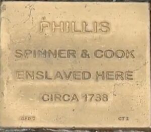 Commemorative plaque for Phillis, a spinner and cook enslaved circa 1738. Honor historical figures and heritage.