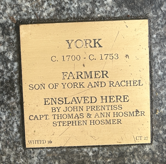 Historical plaque honoring York, an enslaved farmer from 1700s, acknowledging family and those who enslaved him.