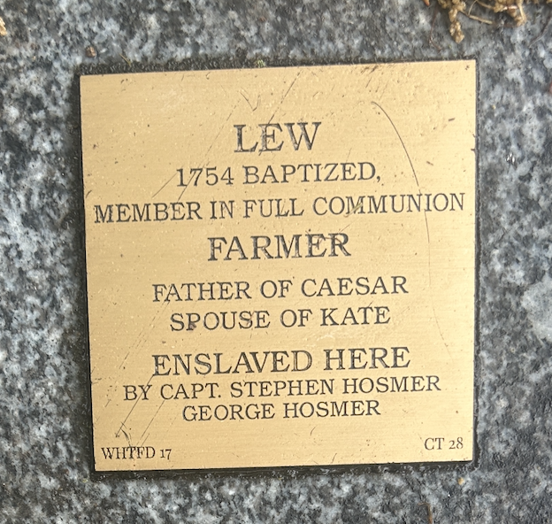 Commemorative plaque for Lew, a baptized farmer, father, spouse, and enslaved by Hosmer captains in 1754.