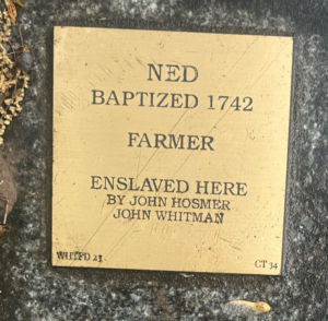 Plaque honoring Ned, baptized 1742, farmer, enslaved by John Hosmer and John Whitman.