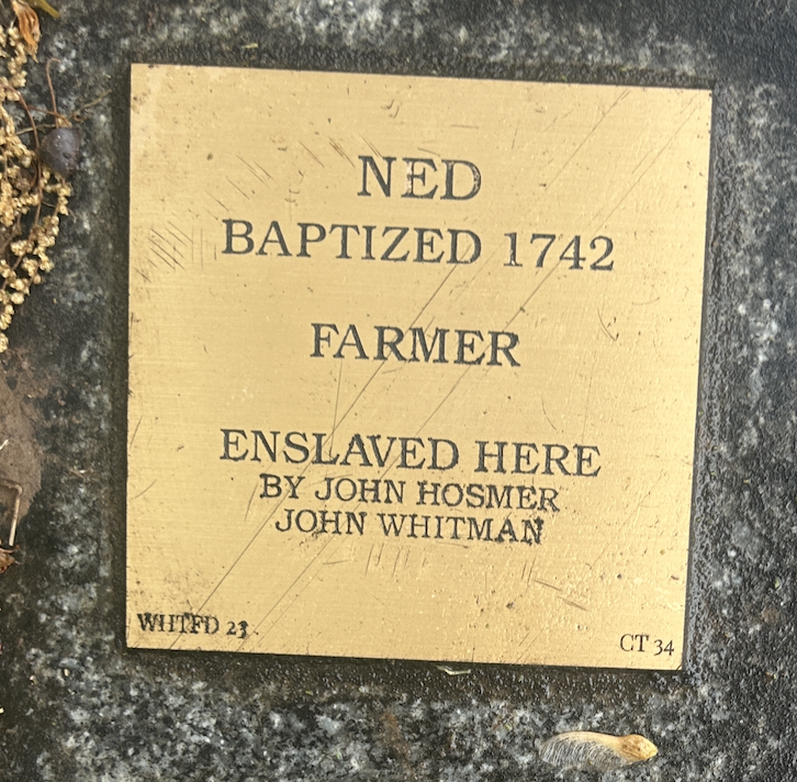 Plaque honoring Ned, baptized 1742, farmer, enslaved by John Hosmer and John Whitman.