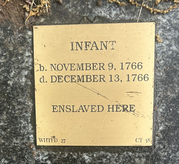 Commemorative plaque for an enslaved infant, born and died 1766 at this site.