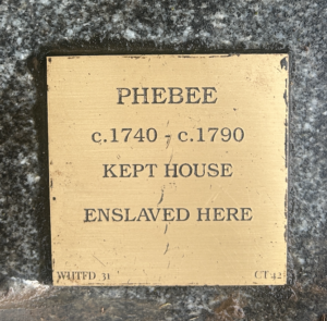 Historical plaque honoring Phebee, an enslaved person, from circa 1740-1790, who maintained the house.