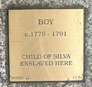 Historical plaque for a boy from 1776-1791, child of Silva, who was enslaved; memorializing past injustices.