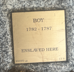 Historical plaque: Boy, 1782-1787, Enslaved Here on a textured surface.