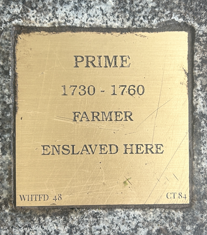 Historical plaque honoring Prime, an enslaved farmer from 1730-1760, highlighting his contribution and legacy.