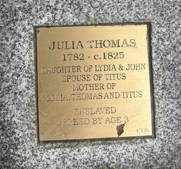 Julia Thomas memorial plaque on granite: born 1782, freed from enslavement by age 3, daughter, spouse, mother.