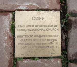 Plaque on brick path detailing history of Cuff's enslavement and connection to Harriet Beecher Stowe's grandfather.