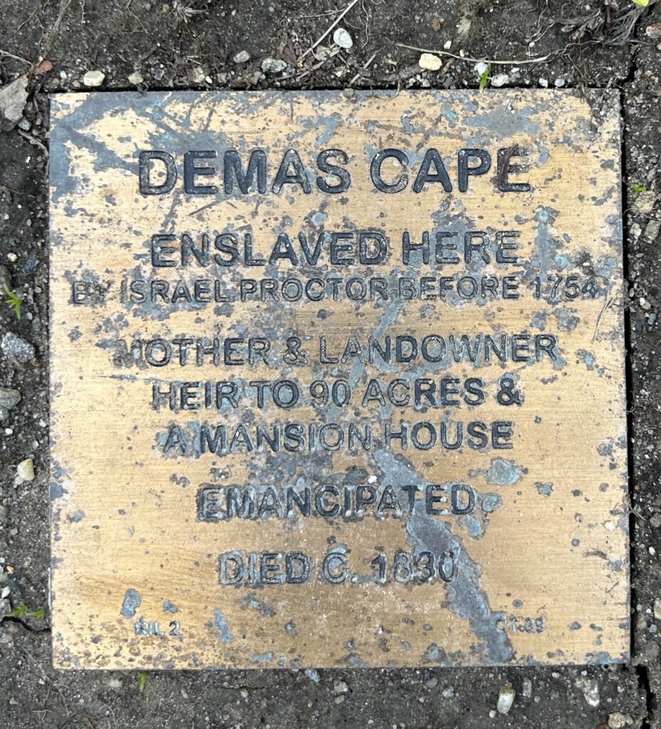 Historical plaque for Demas Cape: enslaved, emancipated, landowner, heir to 90 acres and mansion, died c.1830.
