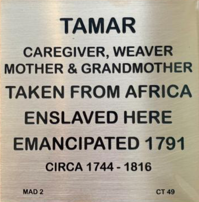 Plaque honoring Tamar, an African caregiver and weaver, emancipated in 1791, detailing life dates 1744-1816.
