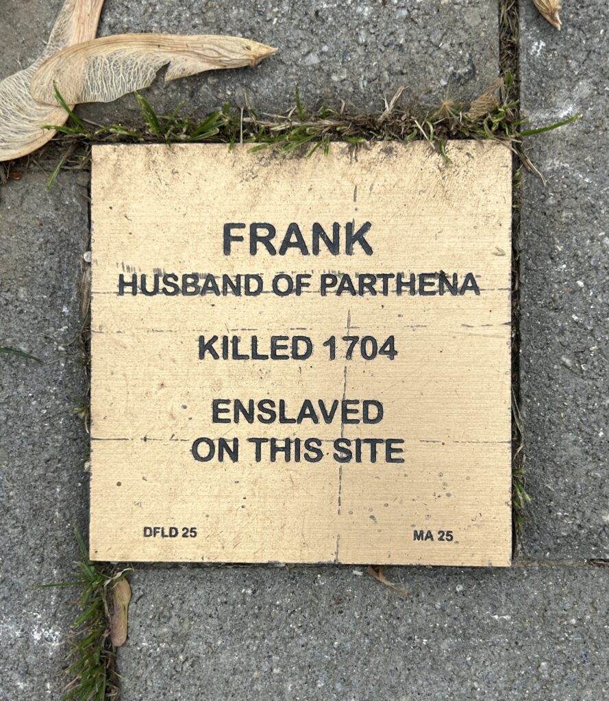 Memorial plaque for Frank, enslaved and killed in 1704; husband of Parthena, marking historical significance.