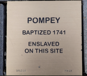 Historical marker for Pompey, baptized 1741, indicates site of enslavement.