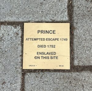 Memorial plaque for Prince, who attempted escape in 1749 and died 1752, enslaved at this site.