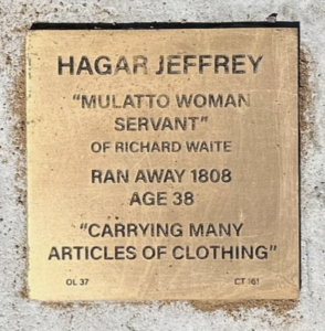 Engraved plaque for Hagar Jeffrey, a servant who escaped in 1808, age 38, described carrying clothing.