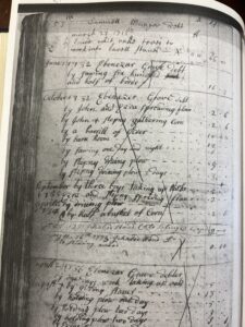Old handwritten ledger page with entries from the 1700s, detailing transactions and labor records.