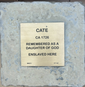 Plaque honoring Cate, enslaved in 1726, remembered as a daughter of God.
