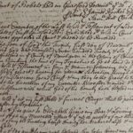 Close-up image of a handwritten 1726 legal document with cursive script detailing a last will and testament.