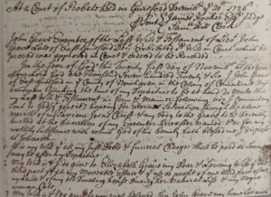 Close-up image of a handwritten 1726 legal document with cursive script detailing a last will and testament.