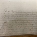 Historic handwritten document, faded ink on aged paper, displaying elegant cursive script and formal language.