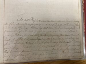 Historic handwritten document, faded ink on aged paper, displaying elegant cursive script and formal language.
