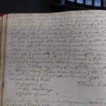 Old handwritten document showcasing historic legal script and ornate penmanship on aged paper.