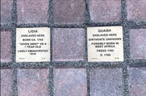 Memorial plaques for Lidia and Quash, commemorating their histories of enslavement and emancipation in 18th-century America.