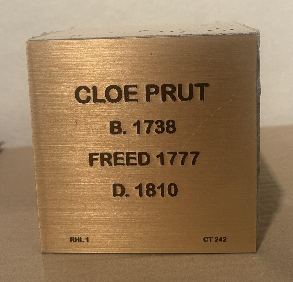 Bronze plaque commemorating Cloe Prut: Born 1738, Freed 1777, Died 1810. Historical remembrance marker.