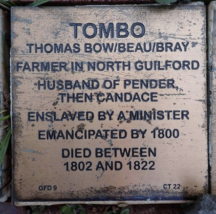 Commemorative plaque for Tombo, a North Guilford farmer and emancipated individual, detailing life events and family.