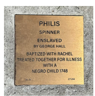 Bronze plaque honoring Philis, an enslaved spinner by George Hall, baptized with Rachel in 1748.