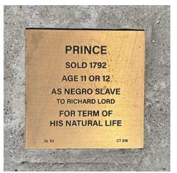 Bronze plaque detailing the 1792 sale of Prince, an 11 or 12-year-old enslaved to Richard Lord for life.