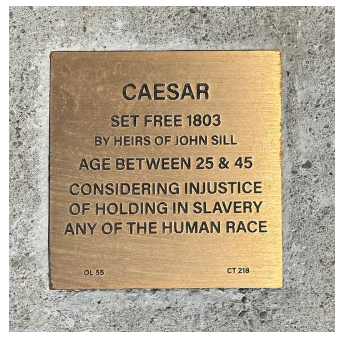 Historic plaque for Caesar, set free in 1803, highlighting the injustice of slavery by John Sill's heirs.