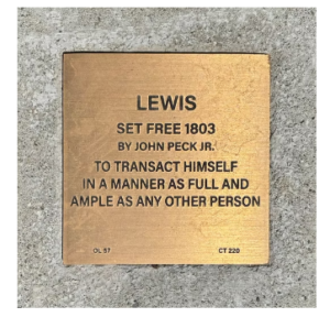 Commemorative plaque for Lewis, set free in 1803 by John Peck Jr., highlighting freedom and equality.