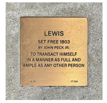 Commemorative plaque for Lewis, set free in 1803 by John Peck Jr., highlighting freedom and equality.