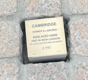 Commemorative plaque for Cambridge, enslaved farmer and laborer, circa 1757, embedded in cobblestone.