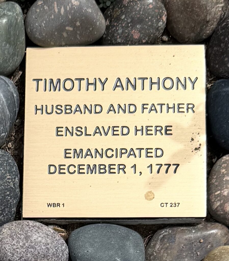 Plaque honoring Timothy Anthony's emancipation on December 1, 1777, surrounded by stones.