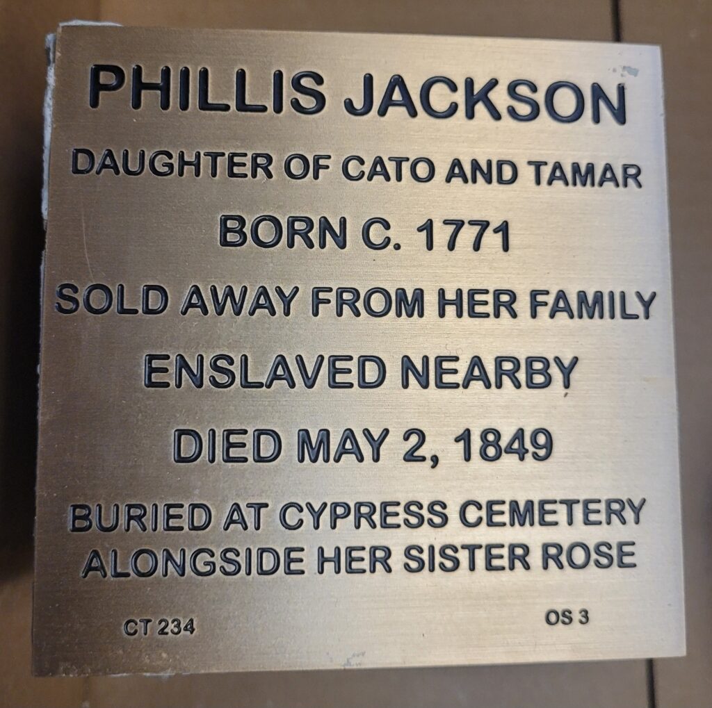 Plaque honoring Phillis Jackson, born 1771, enslaved, died 1849, buried at Cypress Cemetery with sister Rose.