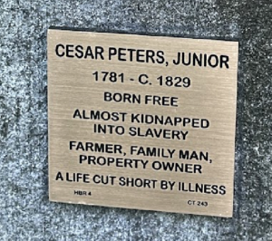 Plaque honoring Cesar Peters, Jr., born free, farmer, family man; highlights resilience against slavery and illness.