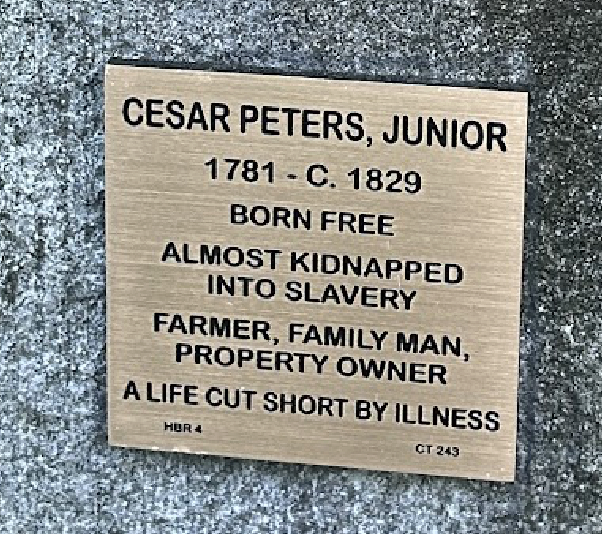Plaque honoring Cesar Peters, Jr., born free, farmer, family man; highlights resilience against slavery and illness.