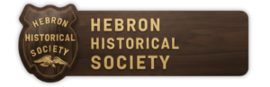 Hebron Historical Society wooden sign with emblem, showcasing local heritage and community history preservation.