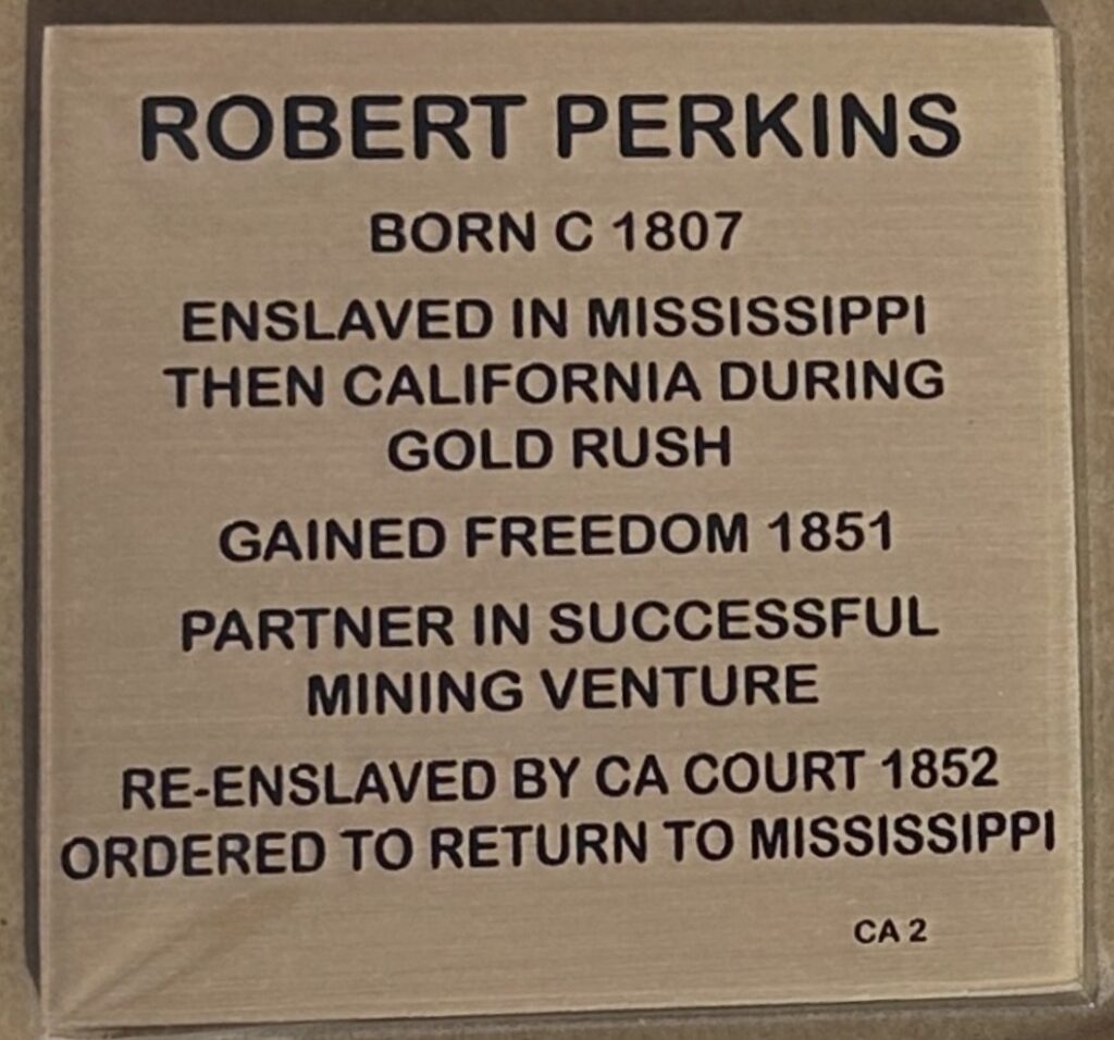 Plaque detailing Robert Perkins' life: From enslavement in Mississippi to freedom during the California Gold Rush era.