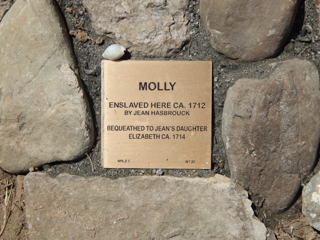 Historical plaque honoring Molly, a woman enslaved circa 1712, bequeathed to Jean Hasbrouck's daughter in 1714.
