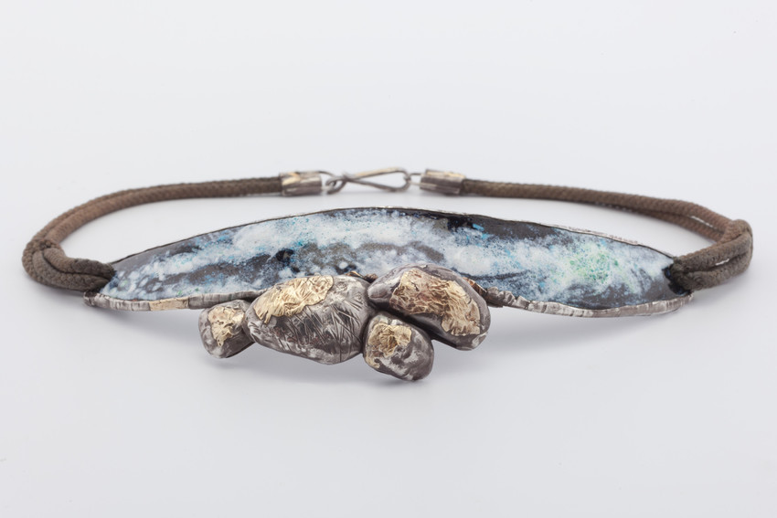 necklace featuring enamel pendant with a silver frame and gold embellishments on a silk braided cord